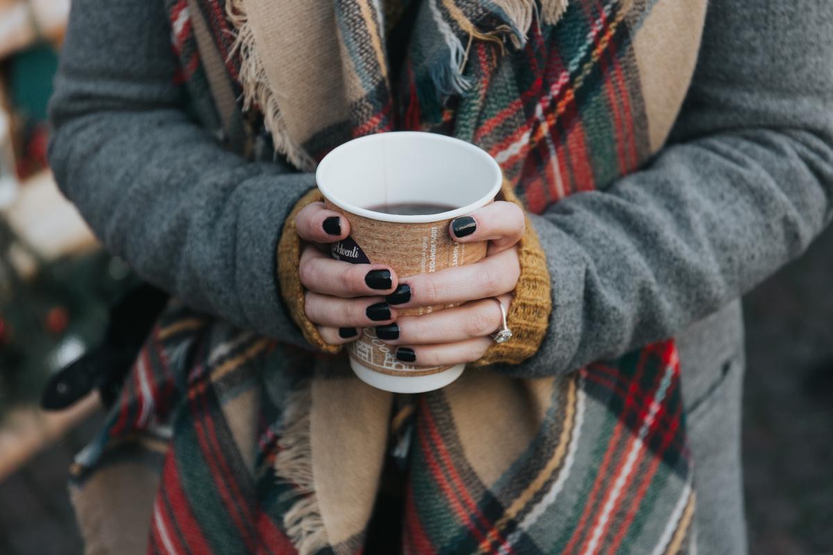 woman in colourful scarf with a cup pf coffee