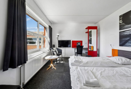 Værelse med senge, skrivebord og opbevaring ved Danhostel Vejen Sport Resort.